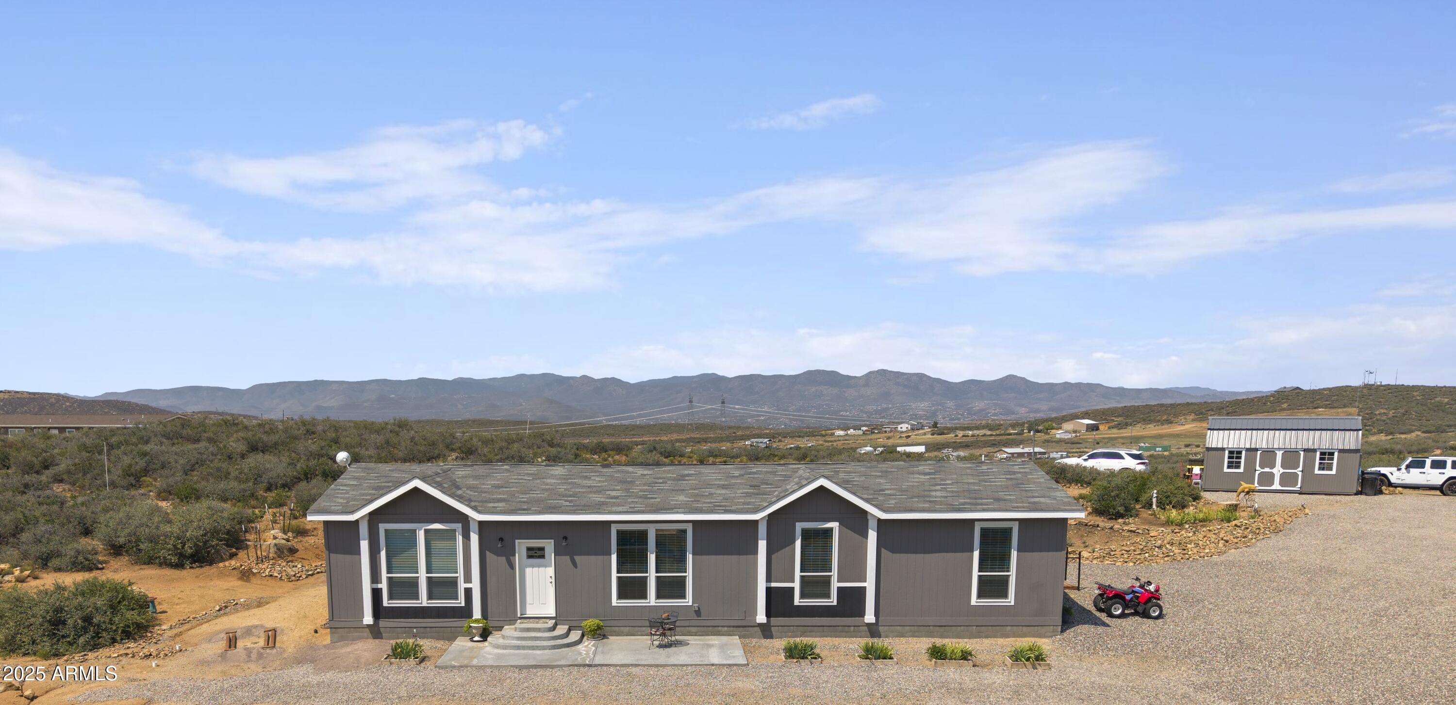1235 North Harvest Road Dewey, AZ 86327 - Photo 2 of 37 a front view of a house with a yard