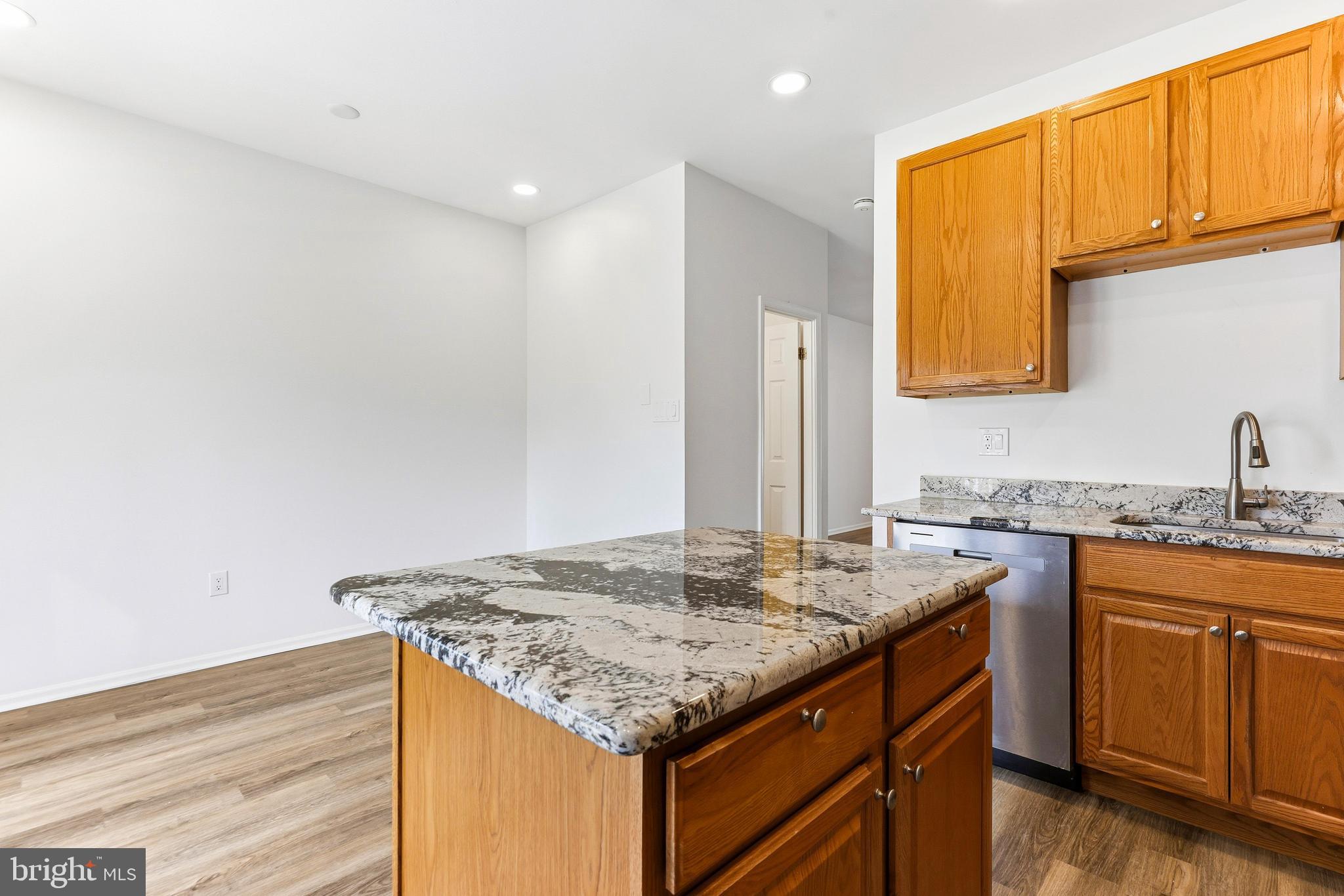 8428 Gold Sunset Way Columbia, MD 21045 - Photo 13 of 43 a kitchen with granite countertop cabinets sink and stove