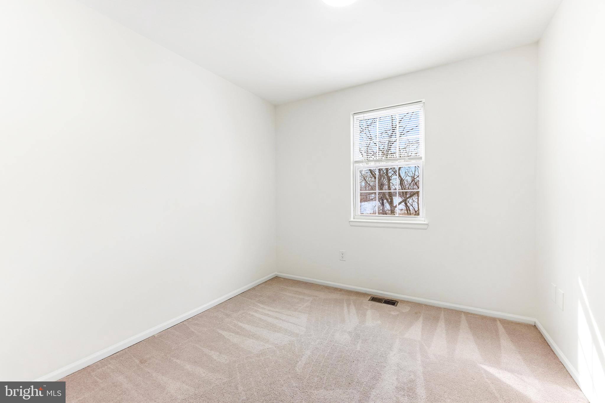 8428 Gold Sunset Way Columbia, MD 21045 - Photo 19 of 43 a view of an empty room with a window