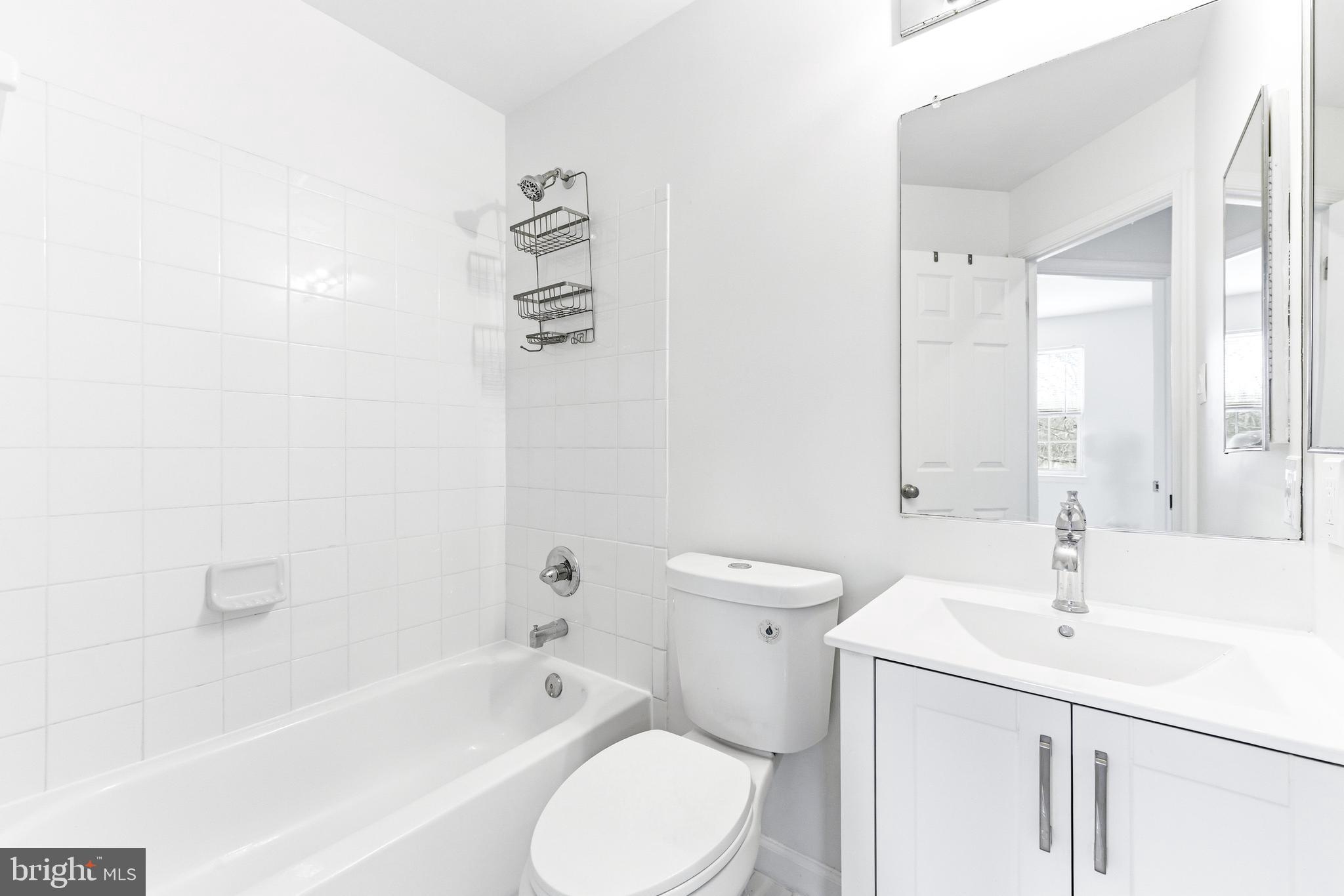 8428 Gold Sunset Way Columbia, MD 21045 - Photo 23 of 43 a bathroom with a sink a toilet and shower
