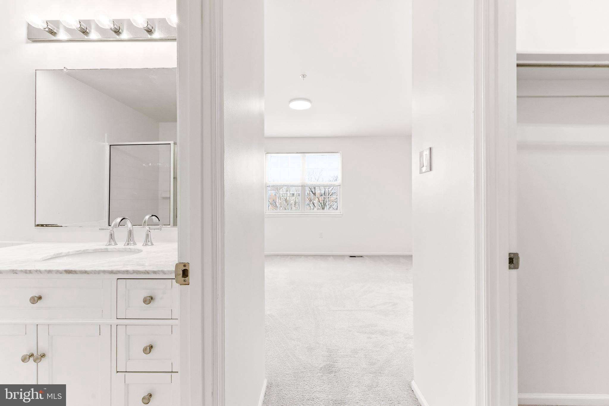 8428 Gold Sunset Way Columbia, MD 21045 - Photo 24 of 43 a bathroom with a granite countertop sink a mirror and a