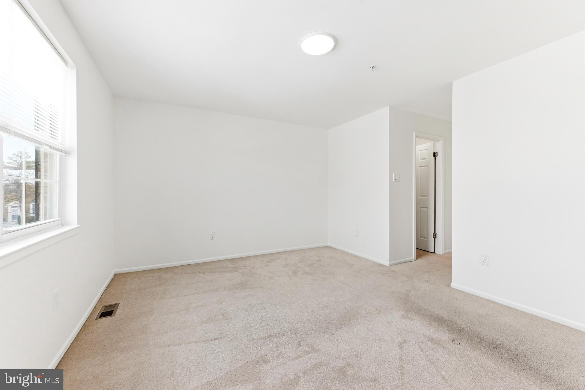 8428 Gold Sunset Way Columbia, MD 21045 - Photo 26 of 43 an empty room with windows