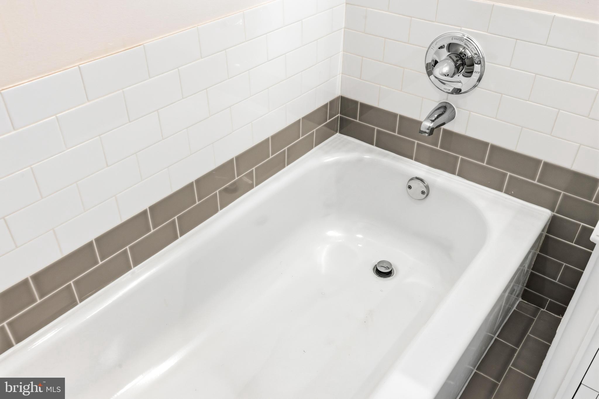 8428 Gold Sunset Way Columbia, MD 21045 - Photo 30 of 43 a bathroom with a bathtub and a shower