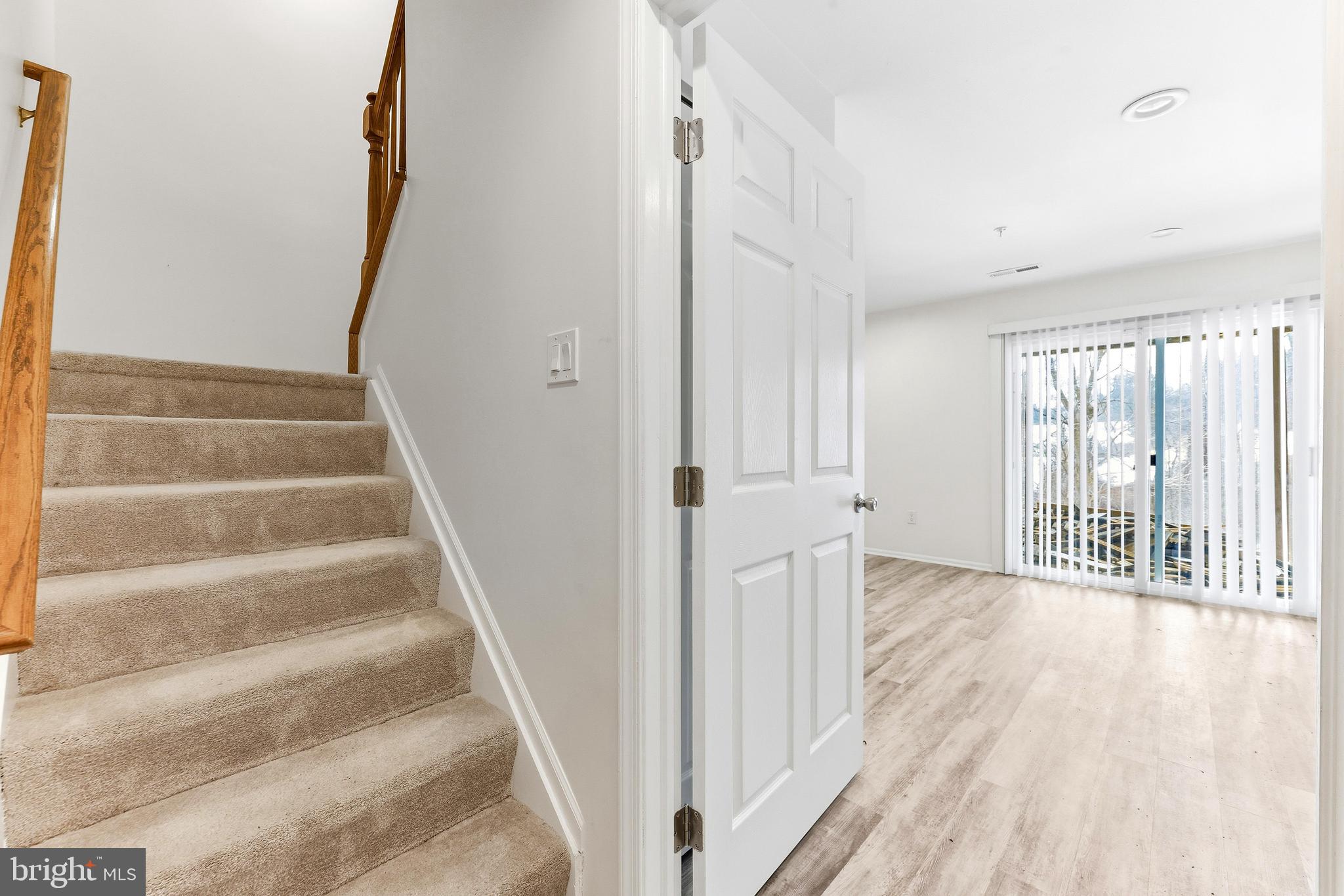 8428 Gold Sunset Way Columbia, MD 21045 - Photo 32 of 43 a view of a hallway with wooden floor and windows