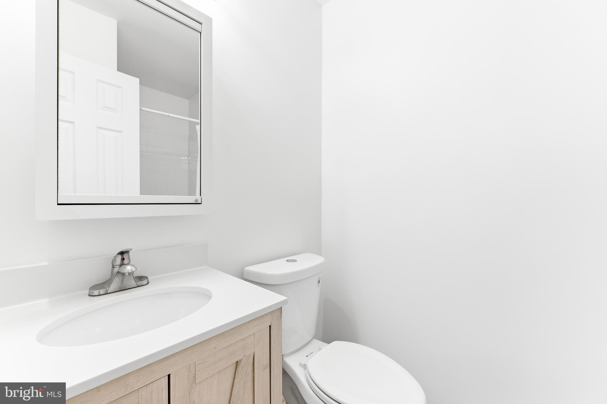 8428 Gold Sunset Way Columbia, MD 21045 - Photo 36 of 43 a bathroom with a sink a toilet and mirror