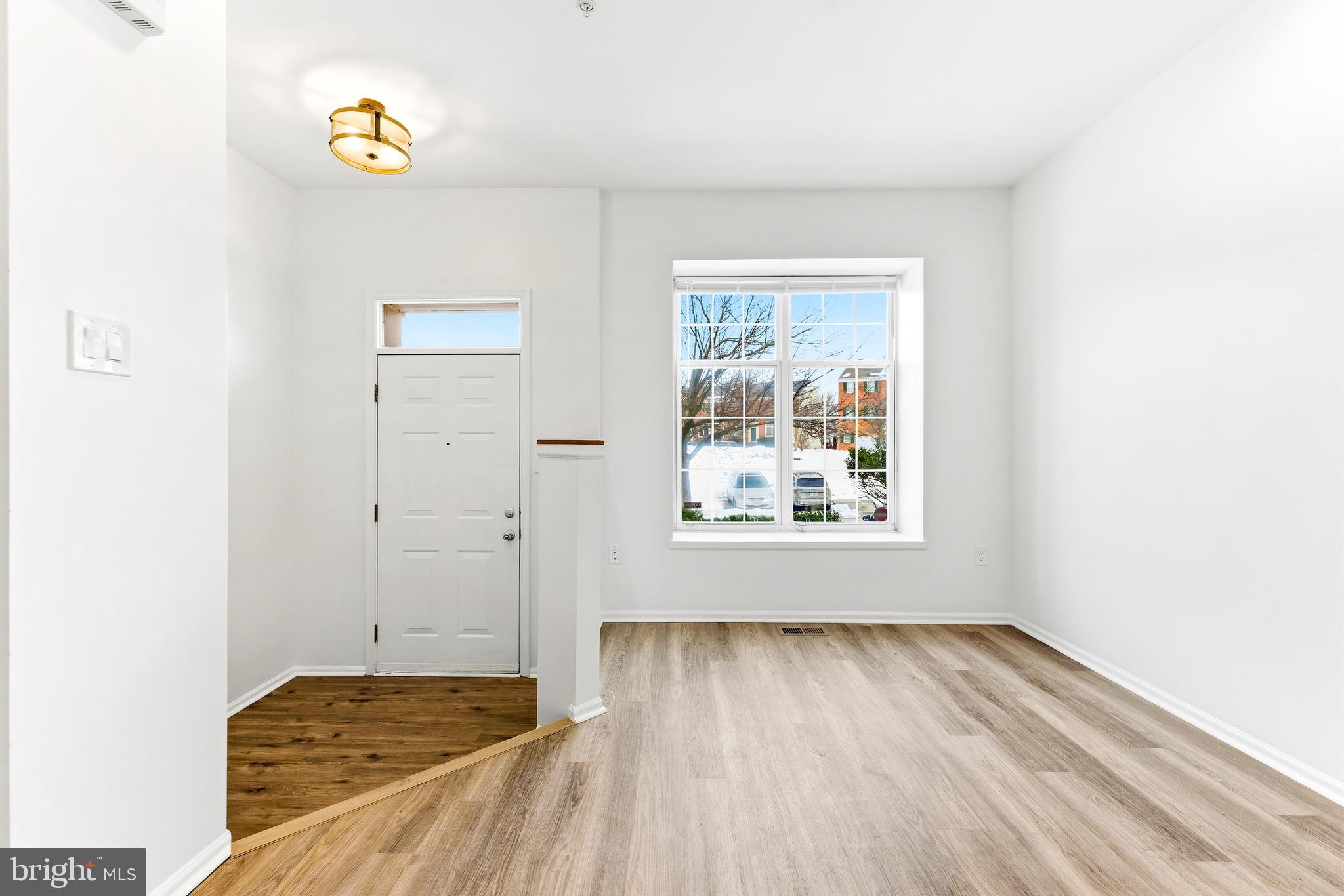 8428 Gold Sunset Way Columbia, MD 21045 - Photo 6 of 43 a view of room with window and wooden floor