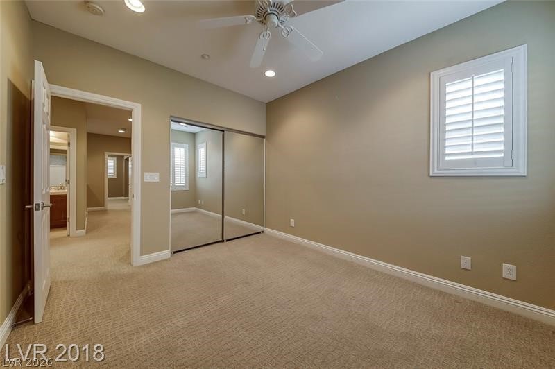 3144 Whitfeild Avenue Henderson, NV 89044 - Photo 28 of 55 A well-lit bedroom features plush carpeting and a convenient mirrored closet.