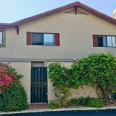 a front view of a house with plants
