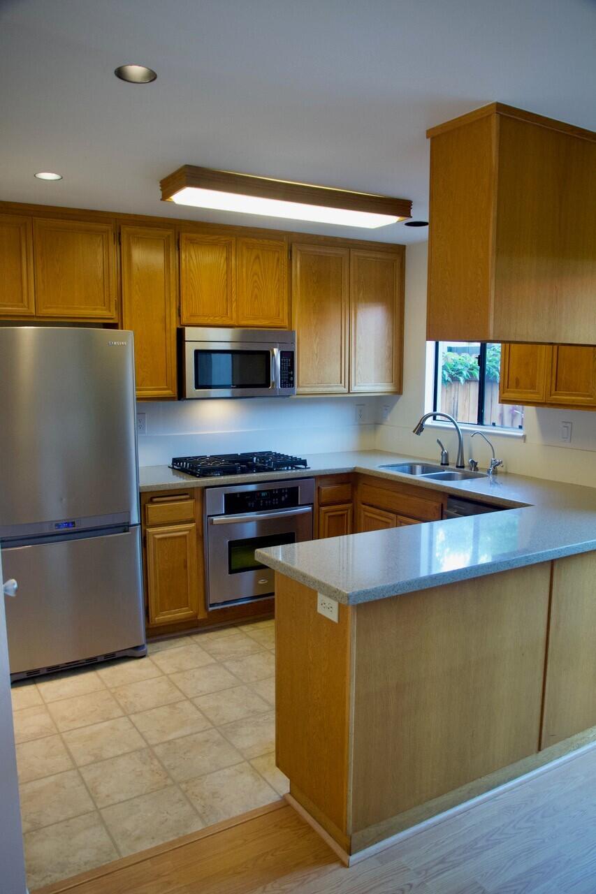 4344 Modoc Road, Unit 3 Santa Barbara, CA 93110 - Photo 5 of 8 a kitchen with kitchen island a counter top space a stove a refrigerator and a sink