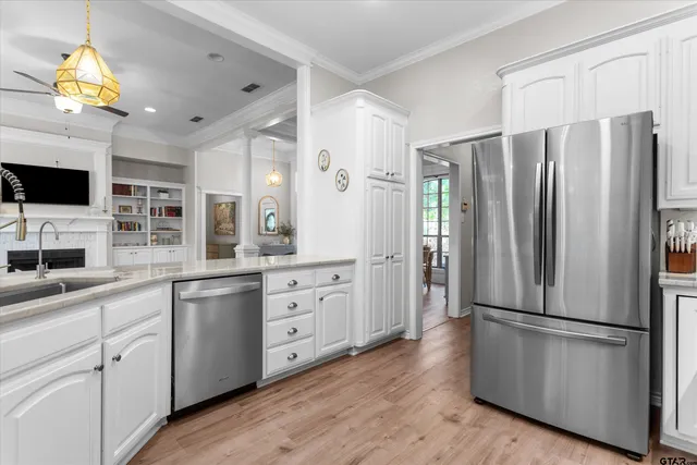 a kitchen with stainless steel appliances a refrigerator sink and microwave