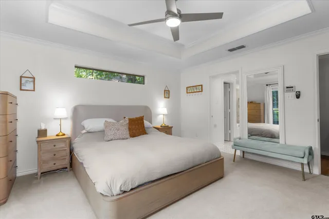 a bedroom with a bed and a view of ceiling fan