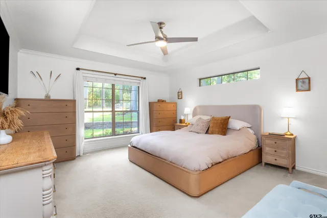 a bedroom with a bed and a dresser next to a window