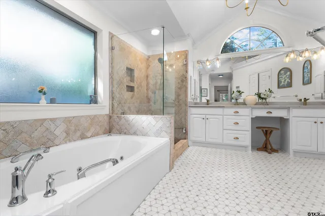 a bathroom with a tub sink and mirror