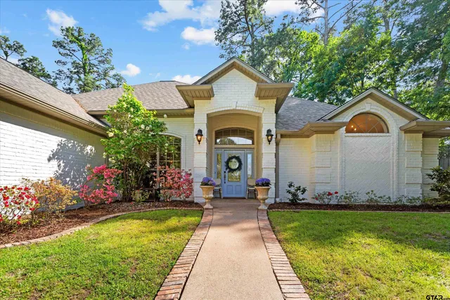 a front view of house with yard and green space
