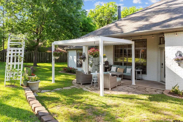 a view of a house with a yard patio and swimming pool