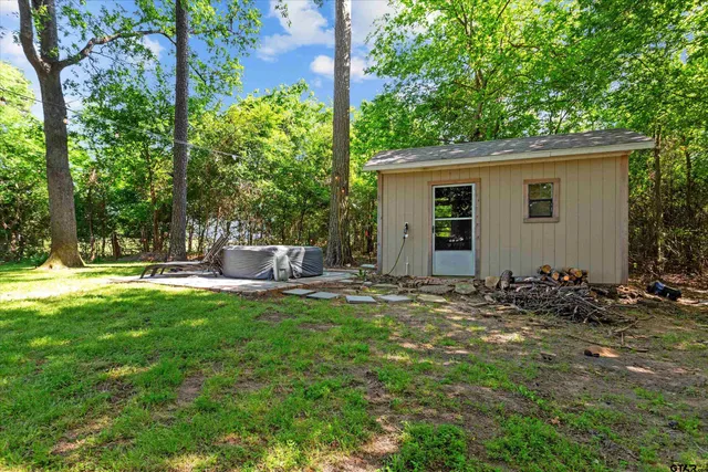 a view of a house with backyard and sitting area