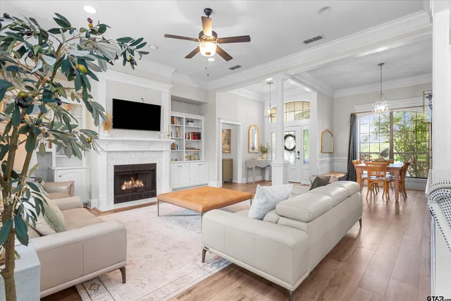 a living room with furniture a fireplace and a flat screen tv