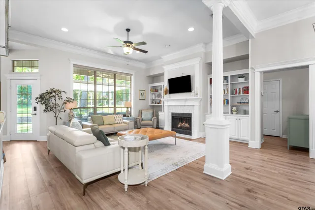 a living room with fireplace furniture and a wooden floor