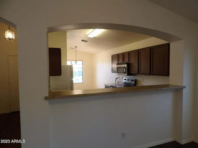 a kitchen with stainless steel appliances a refrigerator and a microwave