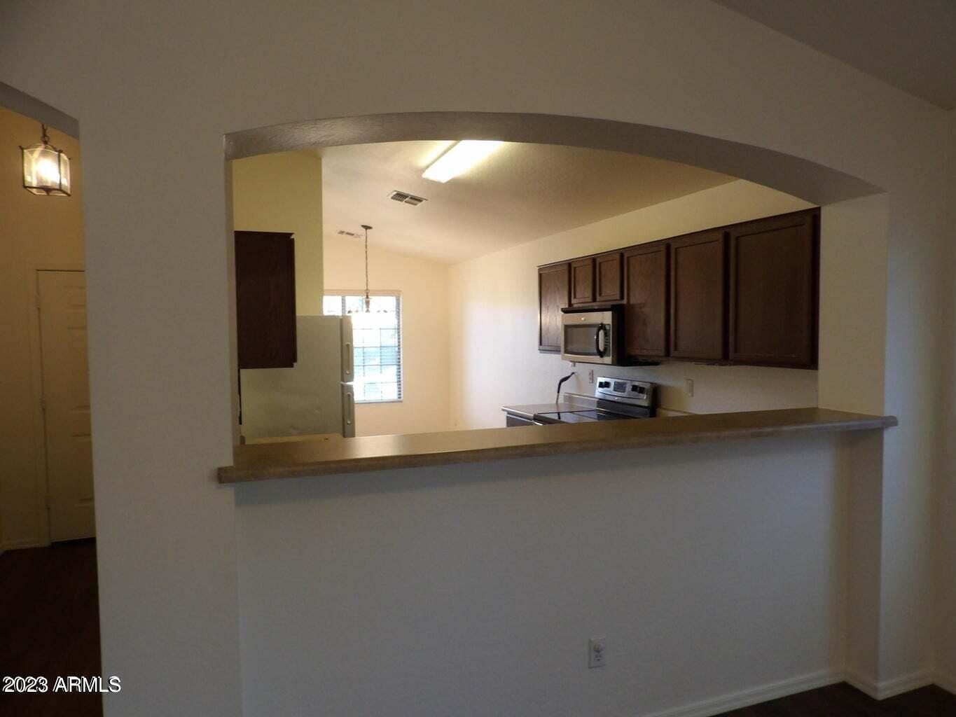 23742 West Hidalgo Avenue Buckeye, AZ 85326 - Photo 12 of 25 a kitchen with stainless steel appliances a refrigerator and a microwave