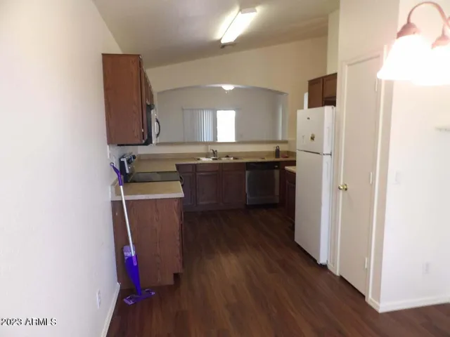 a kitchen with kitchen island a sink stainless steel appliances and cabinets