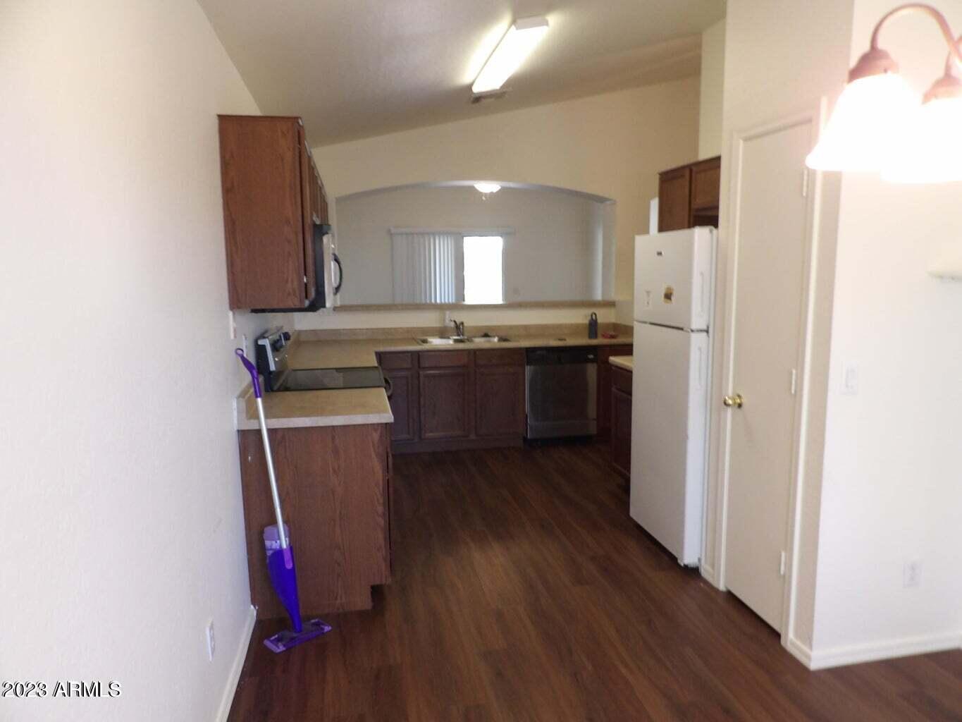 23742 West Hidalgo Avenue Buckeye, AZ 85326 - Photo 13 of 25 a kitchen with kitchen island a sink stainless steel appliances and cabinets