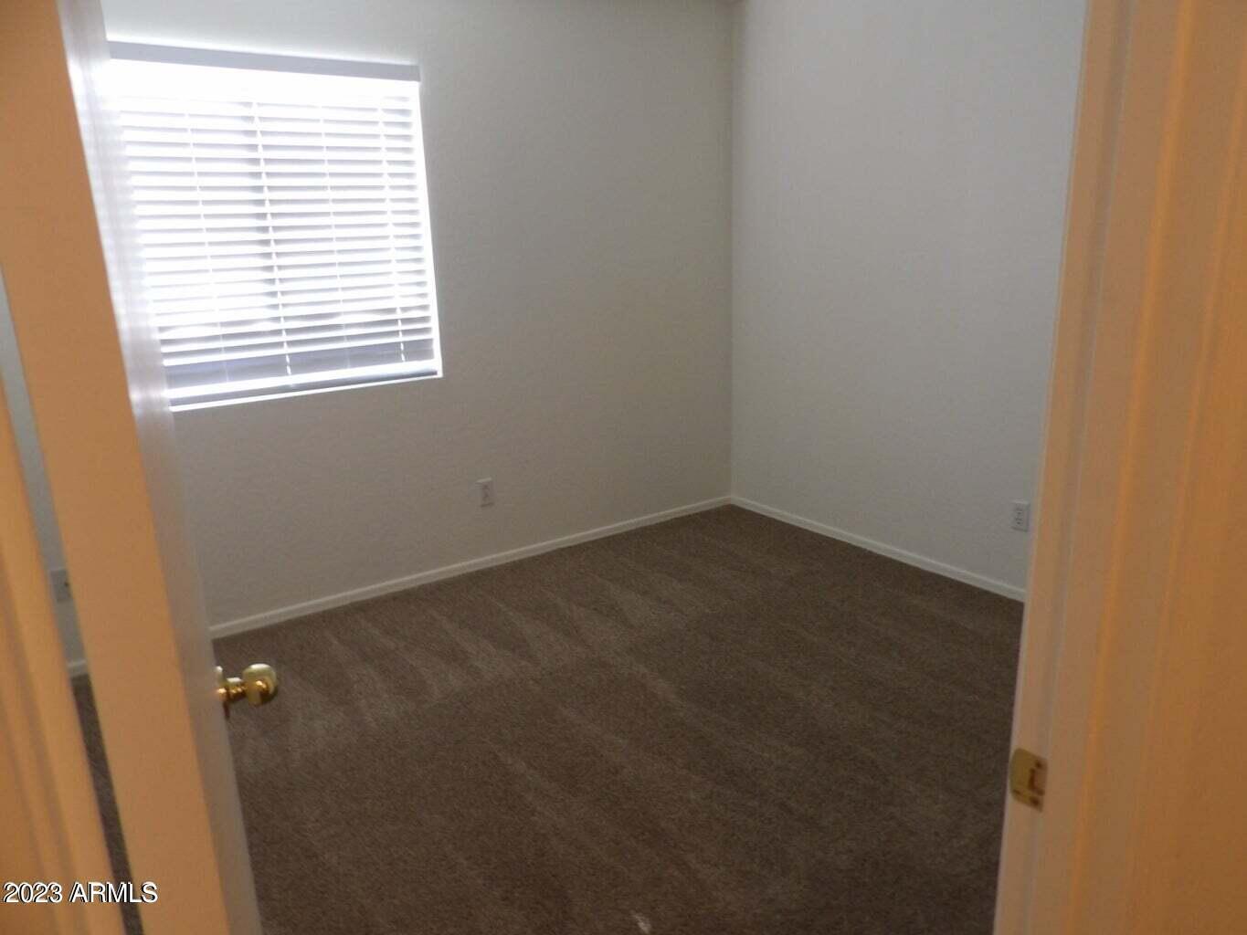 23742 West Hidalgo Avenue Buckeye, AZ 85326 - Photo 22 of 25 an empty room with a window
