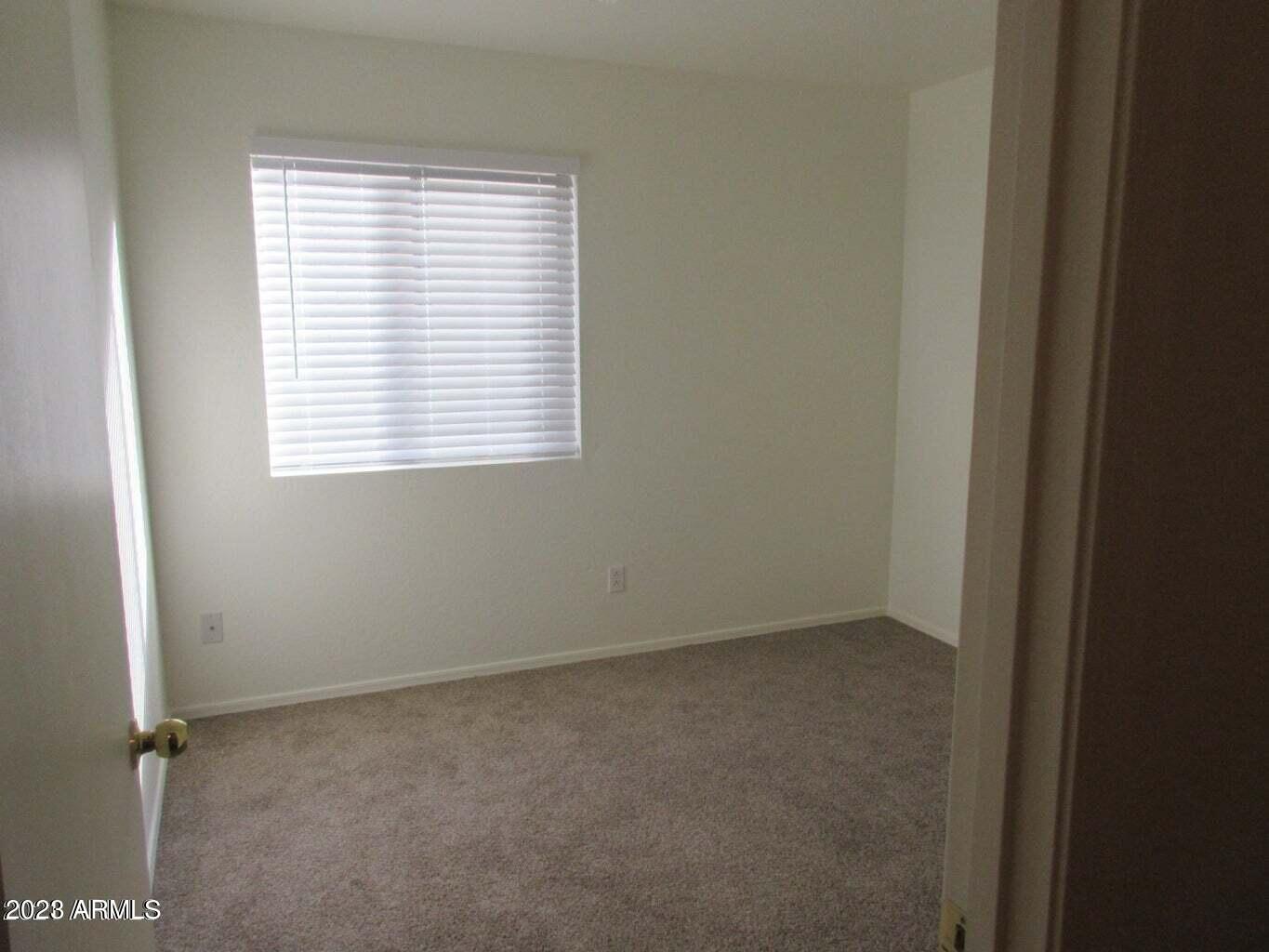 23742 West Hidalgo Avenue Buckeye, AZ 85326 - Photo 23 of 25 an empty room with a window