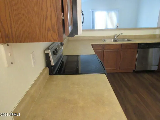 a kitchen with wooden cabinets a sink and dishwasher