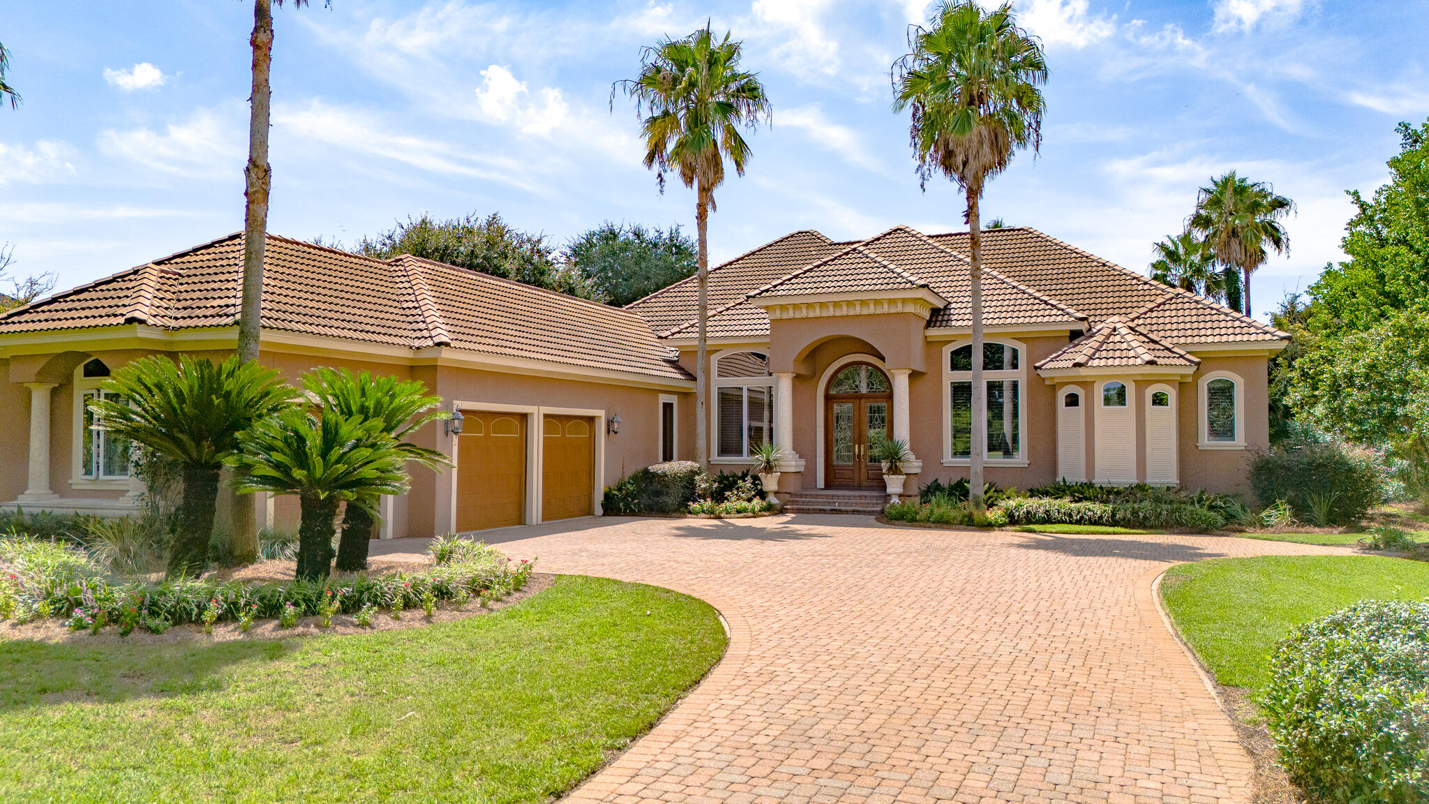 4304 Stonebridge Road Destin, FL 32541 - Photo 1 of 72 a front view of a house with yard and green space