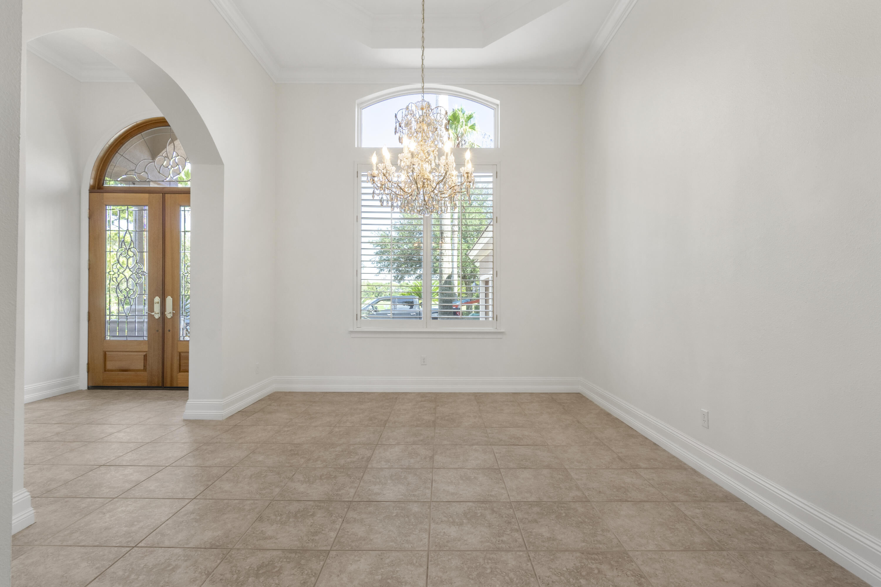 4304 Stonebridge Road Destin, FL 32541 - Photo 13 of 72 an empty room with windows and chandelier