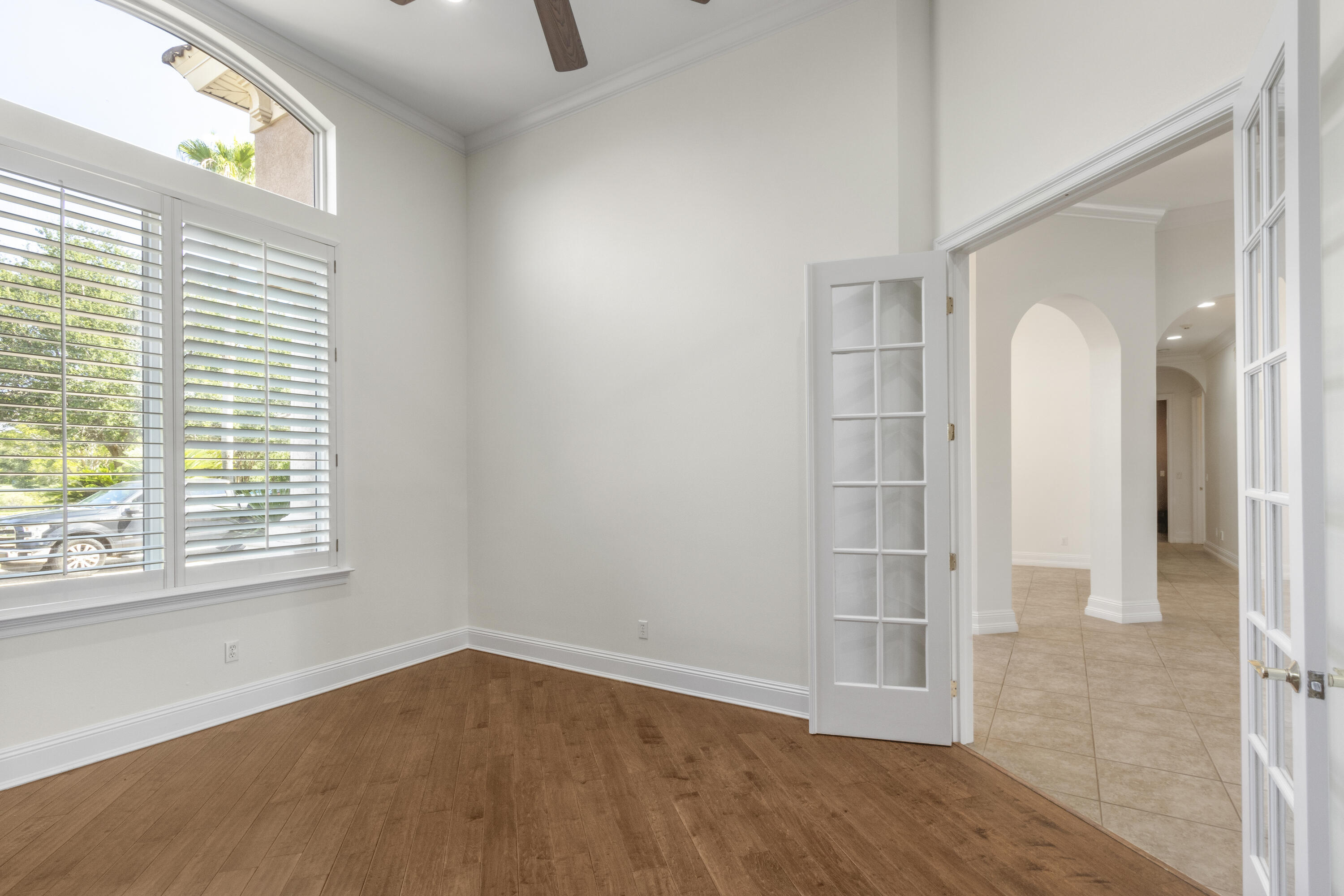 4304 Stonebridge Road Destin, FL 32541 - Photo 17 of 72 an empty room with wooden floor and windows