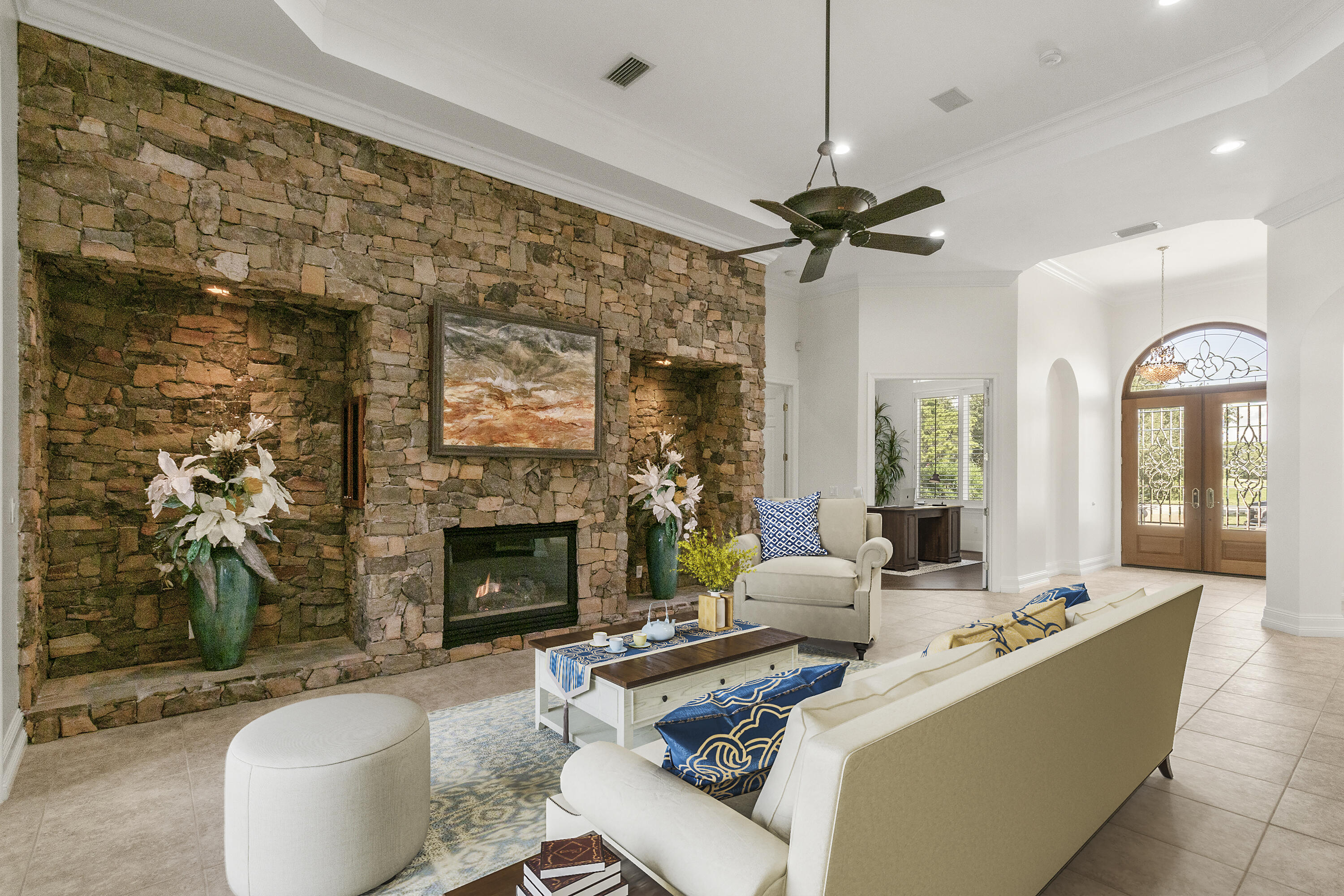 4304 Stonebridge Road Destin, FL 32541 - Photo 24 of 72 a living room with furniture a fireplace and a chandelier