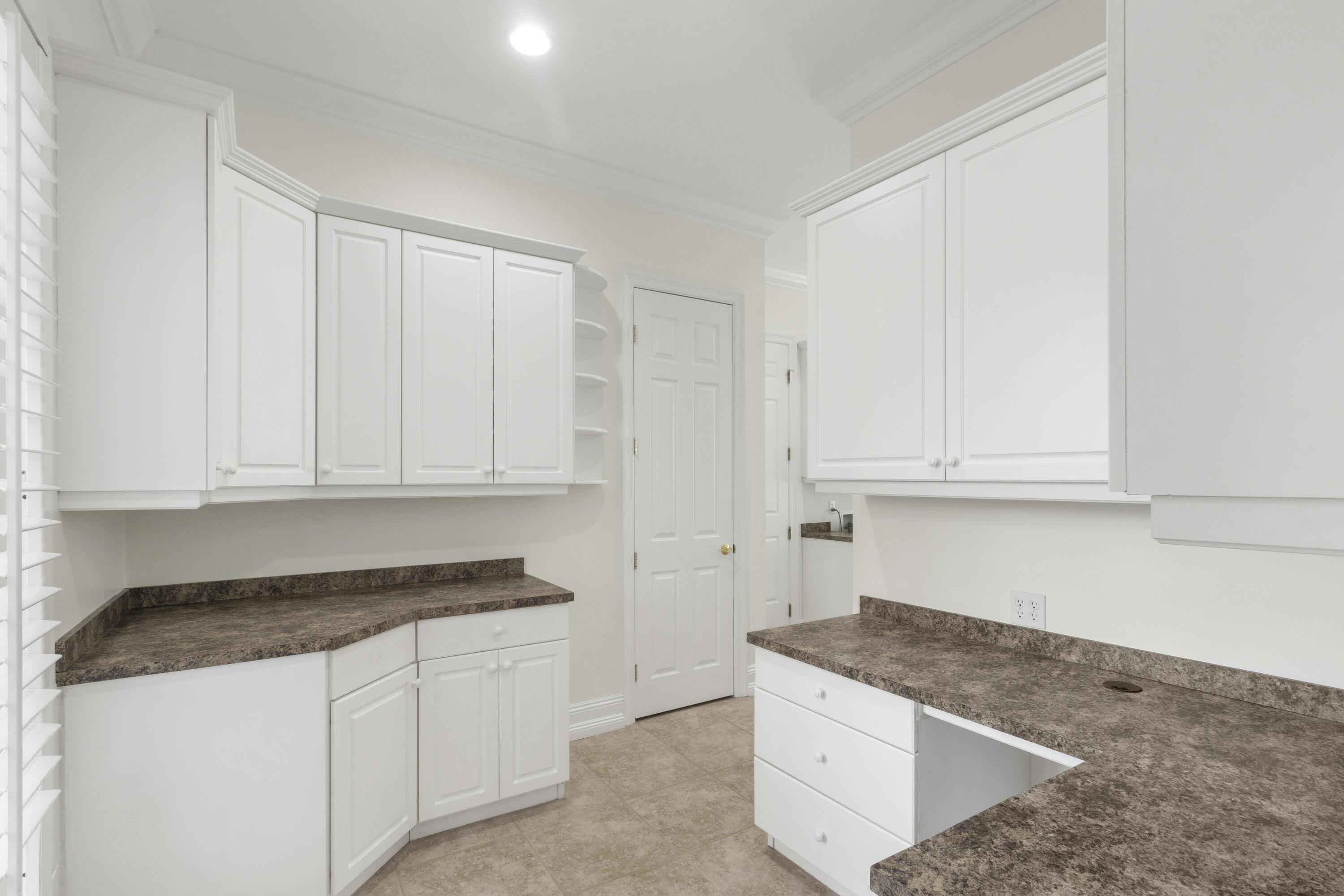 4304 Stonebridge Road Destin, FL 32541 - Photo 42 of 72 a kitchen with granite countertop white cabinets and sink