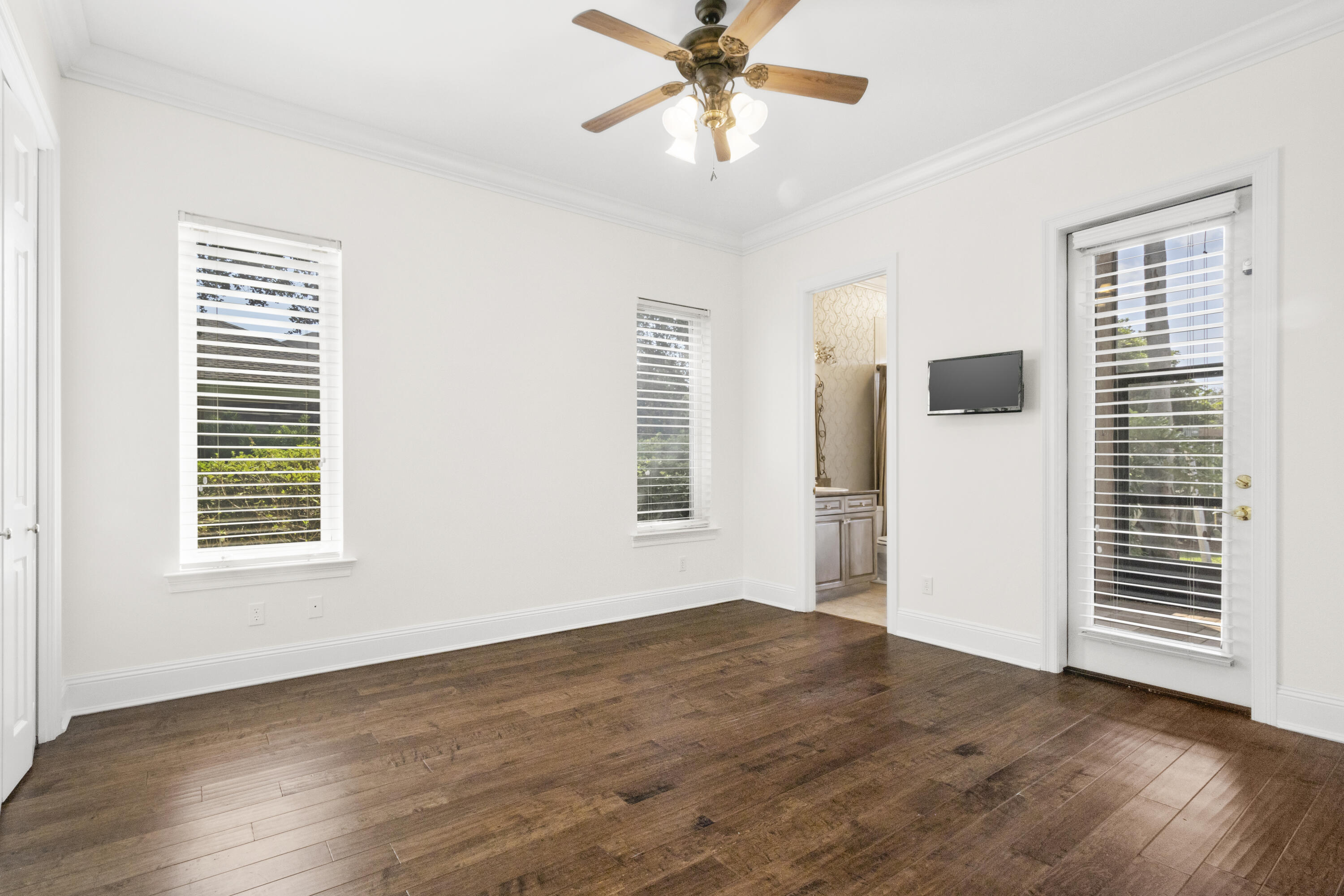 4304 Stonebridge Road Destin, FL 32541 - Photo 44 of 72 a view of an empty room with a window and wooden floor