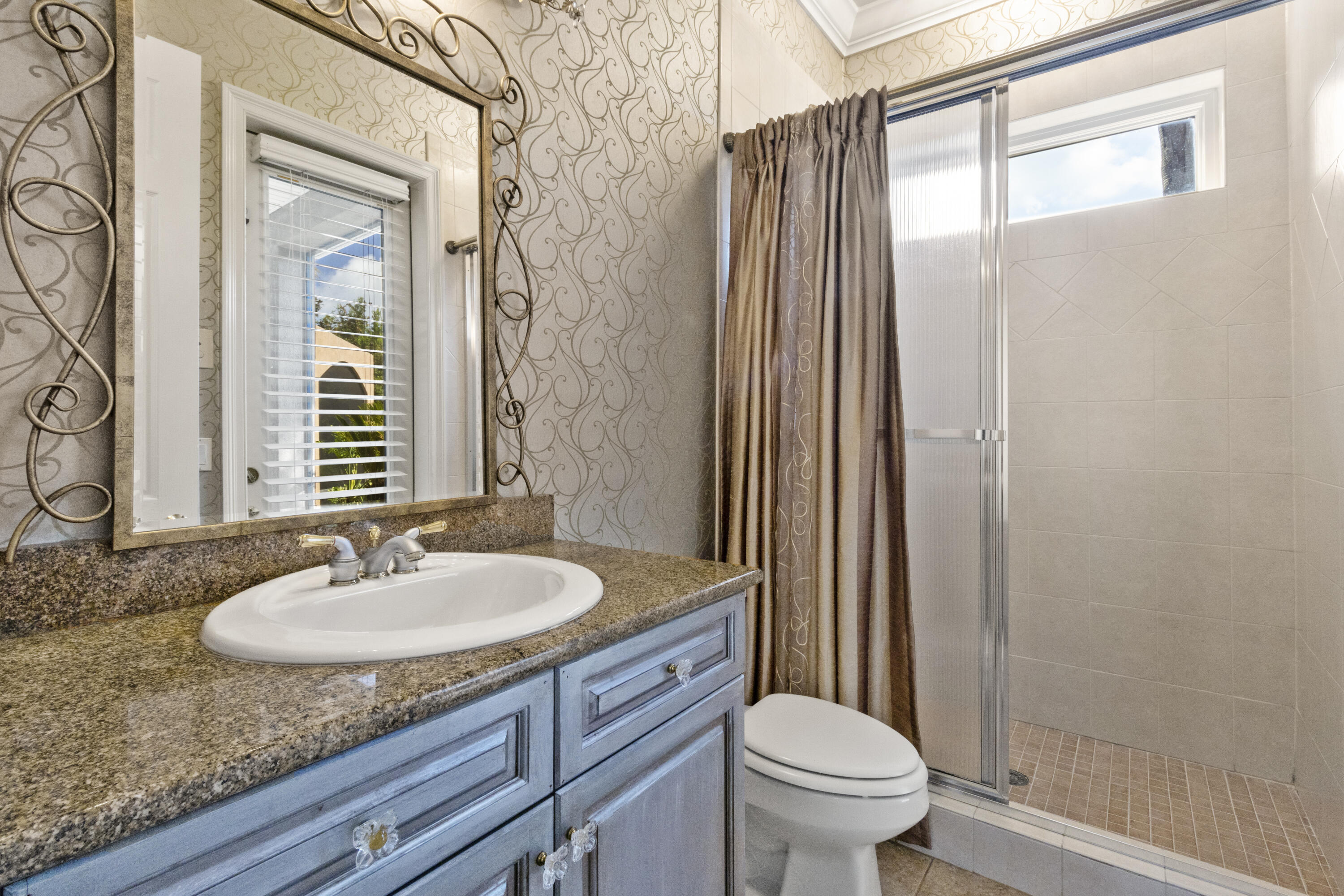4304 Stonebridge Road Destin, FL 32541 - Photo 47 of 72 a bathroom with a granite countertop sink toilet and shower