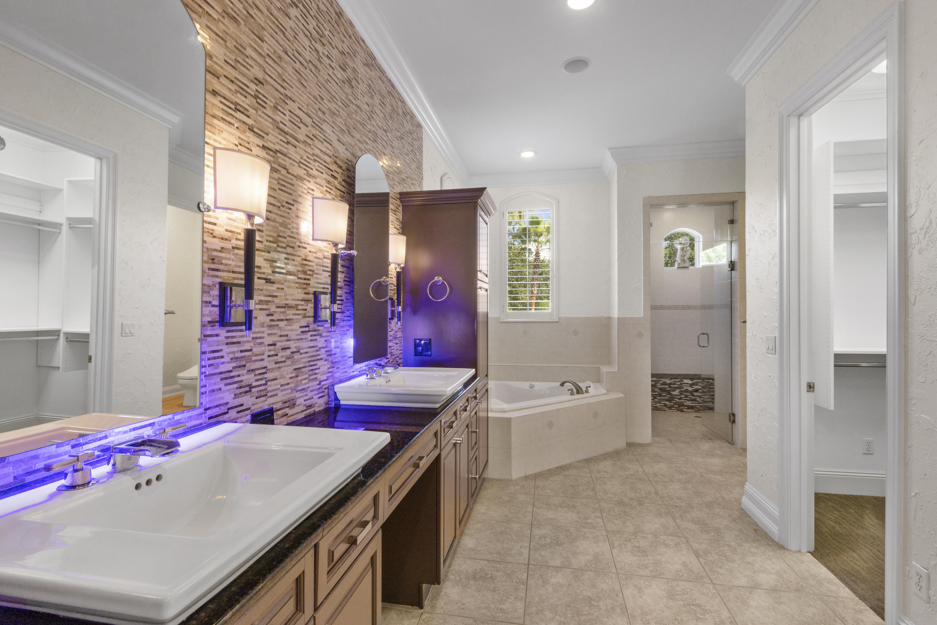 4304 Stonebridge Road Destin, FL 32541 - Photo 54 of 72 a en suite bathroom with a granite countertop tub a sink and a large mirror