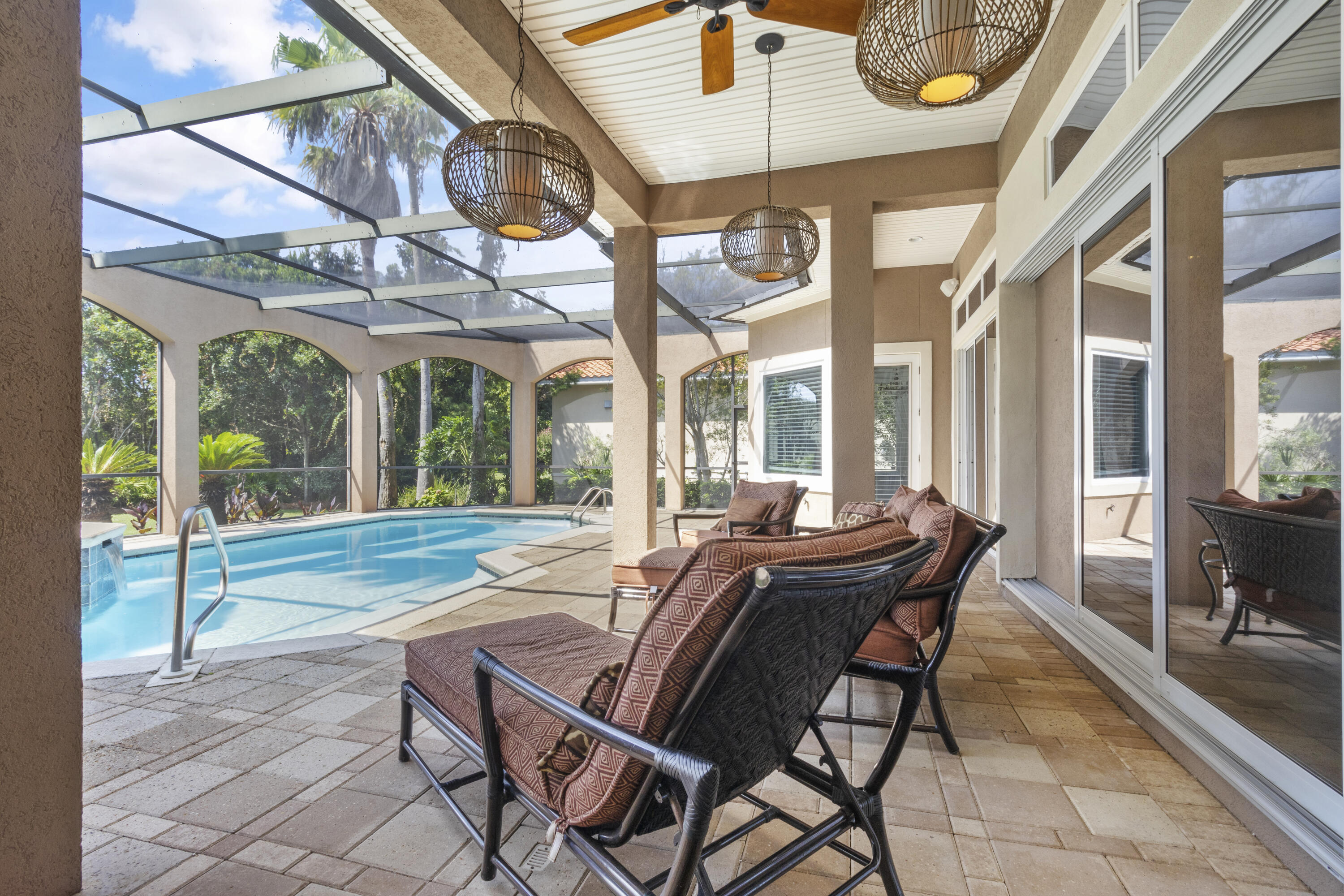 4304 Stonebridge Road Destin, FL 32541 - Photo 59 of 72 a view of a patio with table and chairs and floor to ceiling window