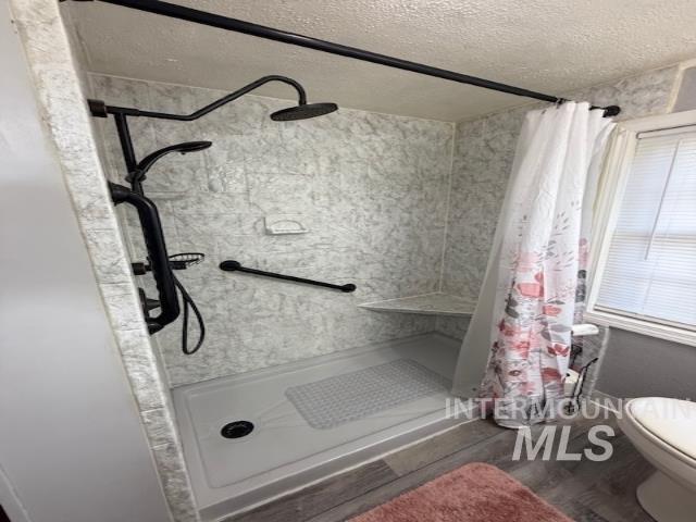 902 East Main Street Weiser, ID 83672 - Photo 30 of 45 Bathroom with a stall shower, a textured ceiling, and dark wood finished floors