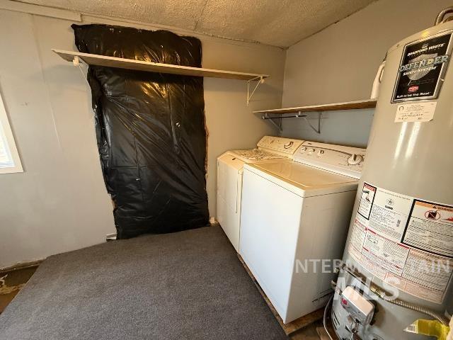 902 East Main Street Weiser, ID 83672 - Photo 37 of 45 Laundry room with gas water heater, washer and dryer, dark colored carpet, and a textured ceiling
