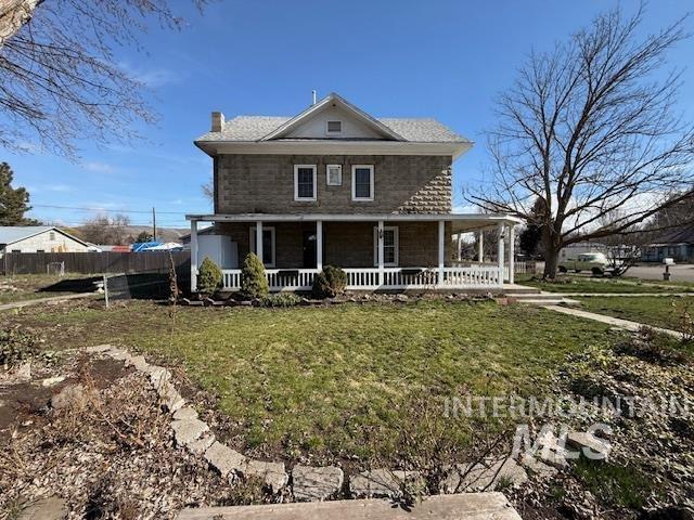 902 East Main Street Weiser, ID 83672 - Photo 41 of 45 View of front of house featuring a front lawn, covered porch, and a chimney