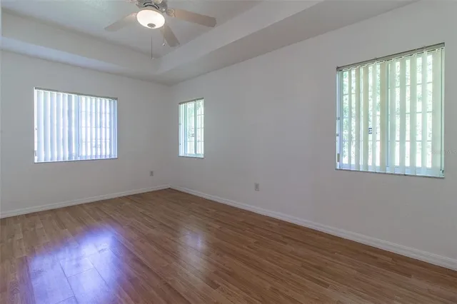 a view of an empty room and wooden floor