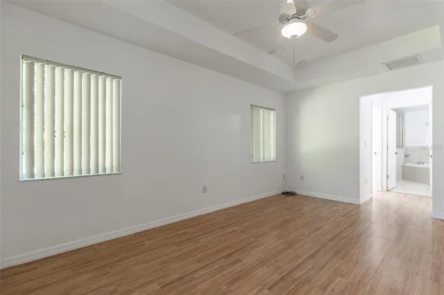 a view of a hallway with a livingroom and a bathroom