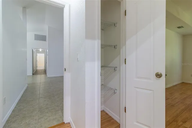 a view of a hallway with wooden floor