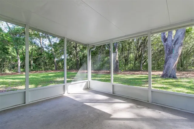 a view of empty room with floor to ceiling windows