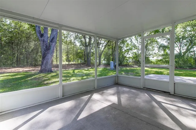 a view of an empty room with a fireplace and a window