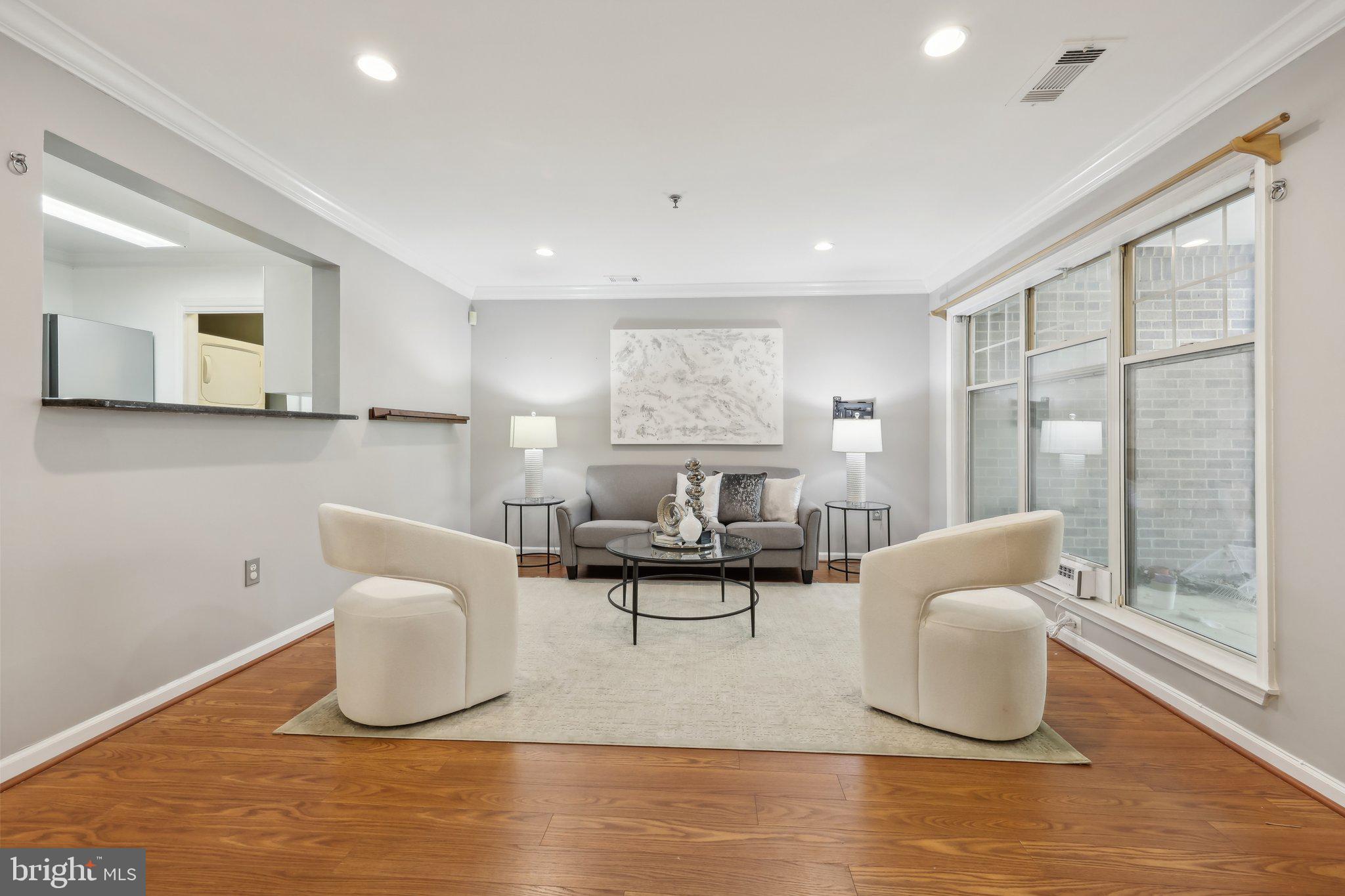 5565 Seminary Road, Unit 108 Falls Church, VA 22041 - Photo 3 of 22 a living room with furniture and a large window