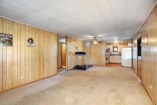 a view of a livingroom with kitchen and furniture