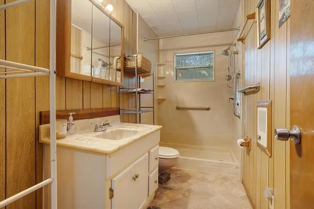 a bathroom with a sink toilet and shower