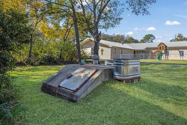 front view of a house with a yard table and chairs